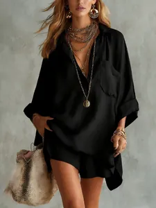 Detail view of stylish black cotton linen shirt and shorts set with gold jewelry