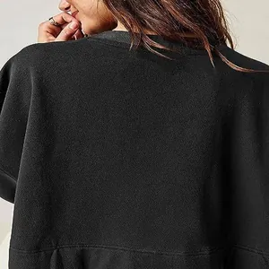Detailed view of high-quality black sweatshirt dress fabric texture and stitching