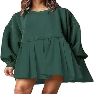 Close-up of a women's forest green oversized sweatshirt dress with a pleated hem.