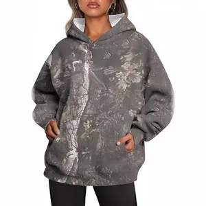 Oversized women's camouflage hoodie featuring a maple leaf print and a convenient front pocket