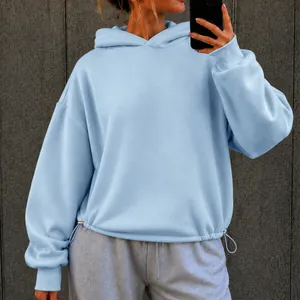 Close-up of light blue oversized hoodie with adjustable drawstring hem for women.