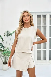 Model wearing a chic cream-colored sleeveless top and wrap skirt set in a bright setting.