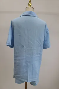 Back view of a casual light blue short-sleeve shirt and shorts set on a mannequin