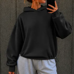 Oversized black hoodie with drawstring hem shown in a street-style mirror selfie