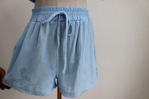 Close-up detail of light blue high-waisted casual shorts with drawstring and elastic waist