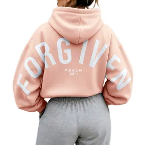 Back view of pink oversized hoodie featuring white "FORGIVEN PSALM 32:1" print detail