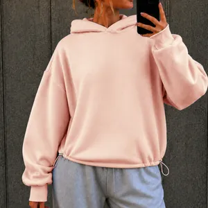 Light pink oversized hooded sweatshirt with drawstring hem and dropped shoulders