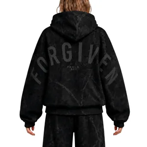 Back view detail of oversized black hooded sweatshirt with FORGIVEN and PSALM 32:1 print