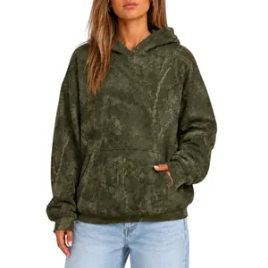 Close-up of olive green oversized hoodie with subtle camo print texture