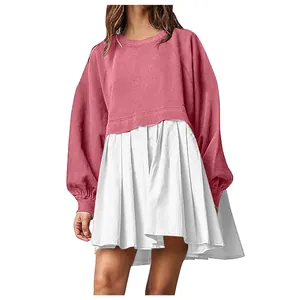 Detail view of the pink and white fake two-piece sweatshirt dress with pleated skirt.