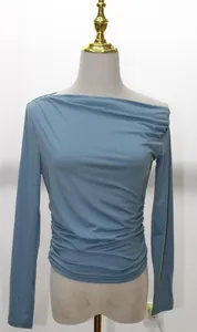 Side ruched detail of a blue asymmetric one-shoulder long-sleeved slim fit top