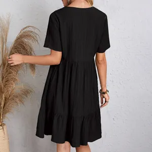 Back view detail of a loose black short-sleeved flowy tiered summer casual dress for women