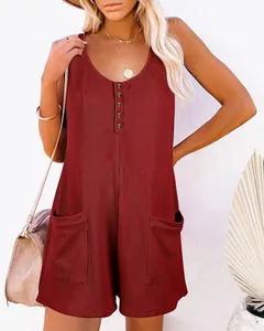 Detail view of a stylish red waffle-knit sleeveless romper featuring buttons and front pockets