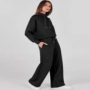 Model wearing a black two-piece casual lounge set with long sleeves and wide-leg pants