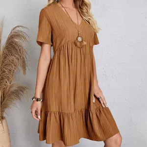 Detail of a brown V-neck short sleeve casual summer dress with tiered ruffle skirt.
