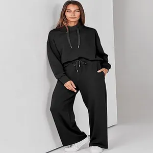 Full-length view of black casual two-piece lounge set with drawstring hoodie and wide-leg pants