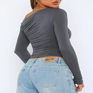 Back view detail of off-shoulder asymmetric long sleeve crop top in charcoal gray
