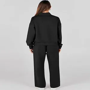 Back view of women's black two-piece loungewear set with long sleeve top and wide pants