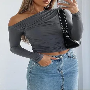 Detailed view of a grey one-shoulder asymmetrical long sleeve slim fit cropped t-shirt.