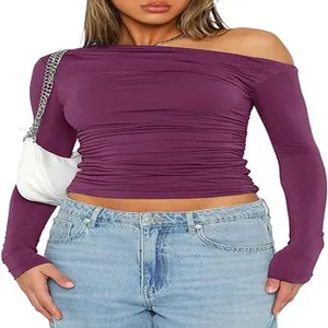 Close-up of a purple off-the-shoulder long-sleeved ruched crop top with slim fit design.