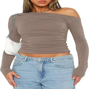 Close-up detail of sexy asymmetric off-shoulder long sleeve ruched slim fit crop top T-shirt