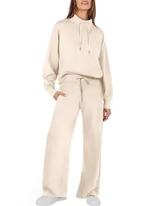 Full-length view of women's cream-colored drawstring hoodie and wide-leg trousers set