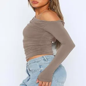 Detailed view of the side ruched texture on a brown off-shoulder long sleeve crop top