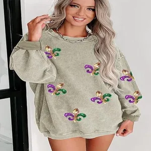 Oversized women's corduroy sweatshirt featuring colorful sequined fleur-de-lis patterns
