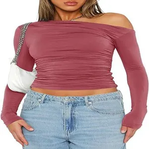 Detailed view of women's pink long sleeve off shoulder ruched asymmetric crop top shirt