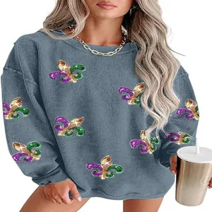 Women's blue crew neck sweatshirt featuring colorful glitter Fleur-de-lis pattern detail.