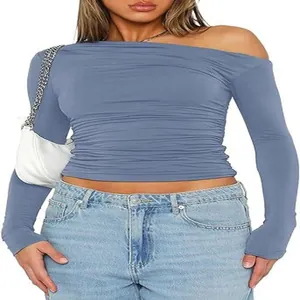 Close-up detail of blue asymmetric off-shoulder long sleeve crop top for women in slim fit