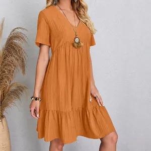 Detailed view of casual orange V-neck short-sleeved mini dress with ruffled hem