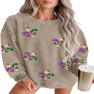 Detail view of women's khaki sweatshirt featuring purple and green sequin fleur-de-lis