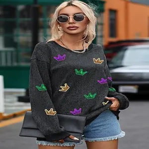 Stylish women's casual grey sweatshirt with colorful crown patches in an urban street setting