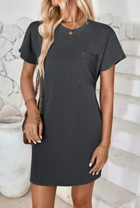 Detailed view of the wavy striped fabric texture and front pocket on this grey dress