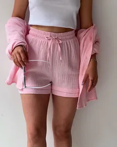 Close-up of pink crinkle fabric two-piece set with shirt and drawstring shorts