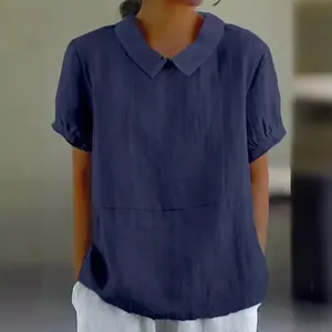 Close-up of a navy blue cotton short-sleeved blouse with a classic Peter Pan collar.