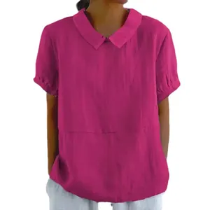 Close-up detail of a vibrant magenta loose fit short sleeve cotton blouse with Peter Pan collar