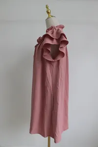 Side detail view of a pink ruffle short sleeve dress on a mannequin