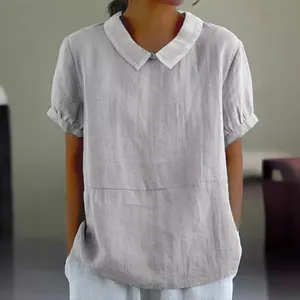 Detailed view of grey cotton blouse with white contrast collar and short sleeves.