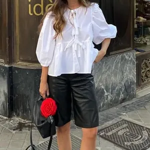 Elegant white puff sleeve blouse featuring sweet front lace-up ties and casual chic style