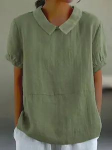 Front view of a loose green short-sleeve cotton blouse with a minimalist lapel collar