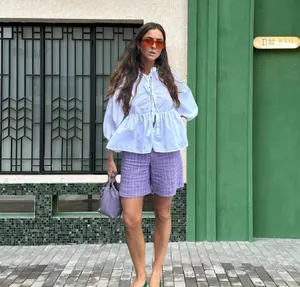 Fashionable white puff sleeve blouse with tie front detail in outdoor setting