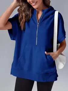 Detailed view of the half-zip and pocket on this blue short sleeve hoodie