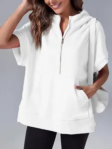 Detail of white short sleeve hoodie featuring half-zip and kangaroo pocket.