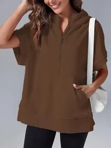 Close-up detail of a casual brown short-sleeved hooded sweatshirt with half-zip and pocket