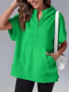 Detailed view of women's bright green short sleeve half-zip hoodie with front pocket