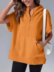 Close-up of a stylish women's orange short sleeve half-zip hoodie with front pocket