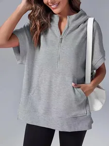 Close-up of grey short-sleeve hooded sweatshirt with half-zip and pocket detail