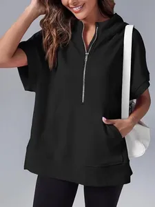 Stylish woman wearing a black short sleeve hooded sweatshirt with a functional half zipper.